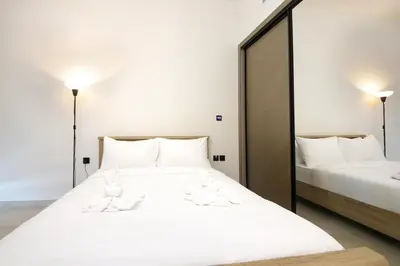a bedroom with a white bed with towels on it at Modern Studio Stay in Business Bay Near Dubai Mall in Dubai