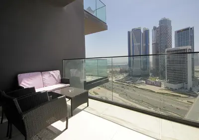 a balcony with a chair and a view of a city at Elegant Studio in Binghatti Canal Near Dubai Mall in Dubai