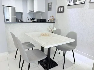 a white table and chairs in a kitchen at Premium Stay - Damac Heights 1BR in Dubai