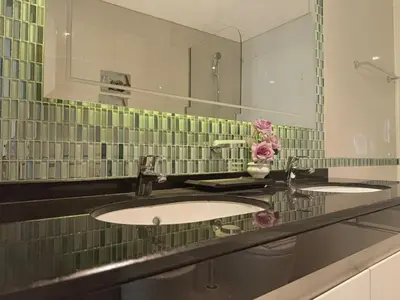 a bathroom with two sinks and a large mirror at Premium Stay - Damac Heights 1BR in Dubai