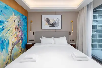 a bedroom with a bed and a painting of a horse at Address Residences, Dubai Opera 1, Downtown - Mint Stay in Dubai