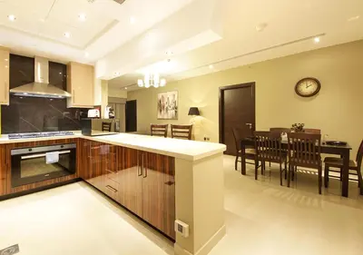 a kitchen and living room with a dining room at 2BR Chic Elite Suite in Downtown near Dubai Mall in Dubai
