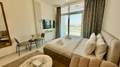 a hotel room with a bed and a large window at Cosy Studio in Carson Tower C in Dubai