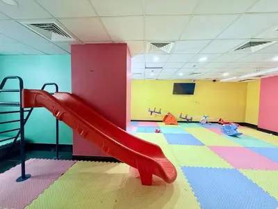 a playground with a slide in a room at LivWithUs-Studio in One BR Setup, Dubai Marina in Dubai