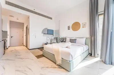 a white bedroom with a large bed and a television at Studio with Glimpse of Burj Khalifa, Minutes from Downtown Dubai, MAG 930, Mohammad Bin Rashid City by Deluxe Holiday Homes in Dubai
