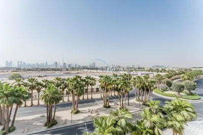 an aerial view of a parking lot with palm trees at Studio with Glimpse of Burj Khalifa, Minutes from Downtown Dubai, MAG 930, Mohammad Bin Rashid City by Deluxe Holiday Homes in Dubai