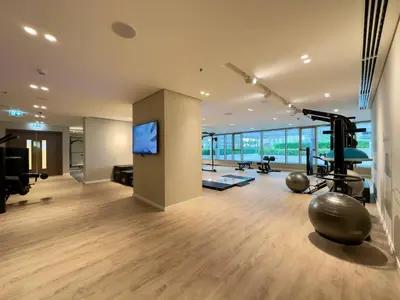 a room with a gym with a flat screen tv at Elegant and Stylish 1BR, Grand Blue in Dubai
