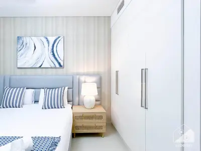 a bedroom with a bed and a table with a lamp at Luxurious Burj Crown 2BR Apartment with Balcony in Dubai