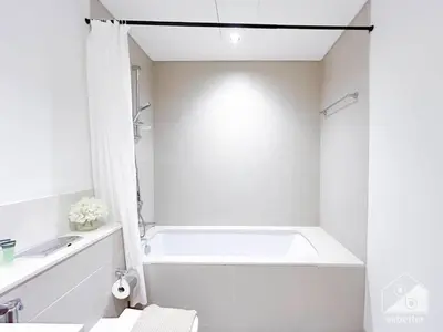 a white bathroom with a tub and a sink at Luxurious Burj Crown 2BR Apartment with Balcony in Dubai