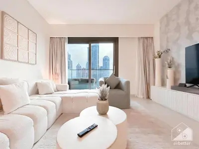 a living room with a white couch and a table at Luxurious Burj Crown 2BR Apartment with Balcony in Dubai