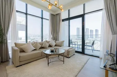 a living room with a couch and a table at TRPS - Azizi Riviera 23, Al Meydan - 2BR Elegant Apartment with Access to Premium Amenities in Dubai