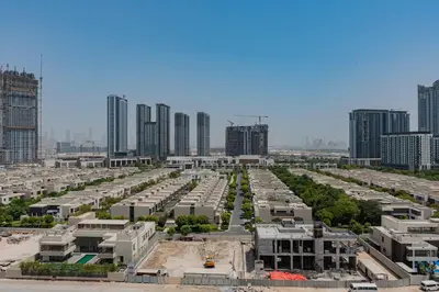 a large parking lot in a city with tall buildings at TRPS - Azizi Riviera 23, Al Meydan - 2BR Elegant Apartment with Access to Premium Amenities in Dubai