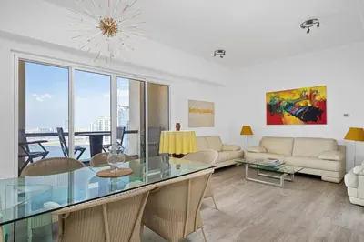 a living room with a glass table and a couch at Ain Vista - Rimal 5 - JBR in Dubai