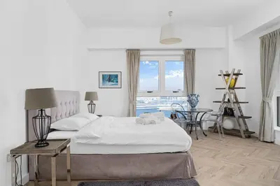 a bedroom with a bed and a table and a window at Ain Vista - Rimal 5 - JBR in Dubai