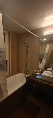 a bathroom with a tub and a sink and a bath tub at JLT 1BR Marina Skyline View in Dubai