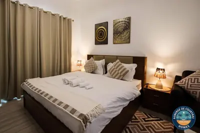 a bedroom with a bed with two towels on it at Modern Studio Fully Furnished Oxford Residence in Dubai