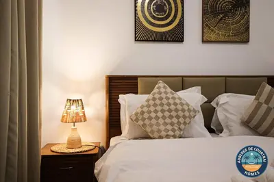 a bedroom with a bed and a lamp on a night stand at Modern Studio Fully Furnished Oxford Residence in Dubai