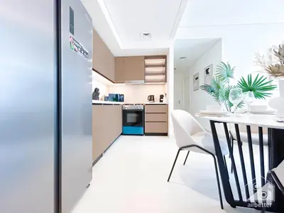 a kitchen and dining room with a table and chairs at Full Luxury at Burj Crown 2B with City Views in Dubai