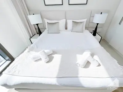 a white bed with two white socks on it at Full Luxury at Burj Crown 2B with City Views in Dubai