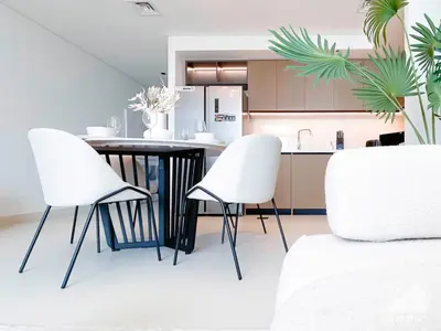 a kitchen with a table and two white chairs at Full Luxury at Burj Crown 2B with City Views in Dubai