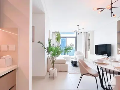two views of a living room and a dining room at Full Luxury at Burj Crown 2B with City Views in Dubai