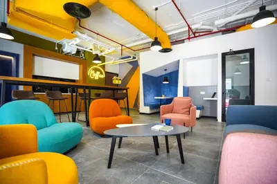 a room with colorful chairs and a table at YouCo Dubai apart-hotel in Dubai