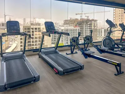 a gym with cardio equipment in a building at New 1BR with Full Balcony Gym Pool and Sauna in Dubai