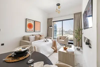 a white living room with a bed and a table at New 1BR with Full Balcony Gym Pool and Sauna in Dubai