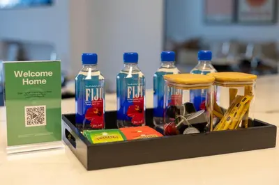 a box with four bottles of water on a table at New 1BR with Full Balcony Gym Pool and Sauna in Dubai