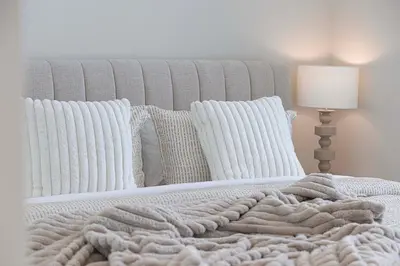 a white bed with a blanket and pillows at 5 Star Amenities 10 Mins Downtown Kite Beach in Dubai