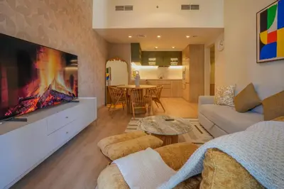 a living room with a couch and a tv at 2 bedroom Apartment Dubai Marina in Dubai