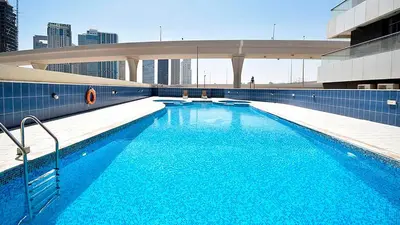 a large blue swimming pool on top of a building at 2 bedroom Apartment Dubai Marina in Dubai