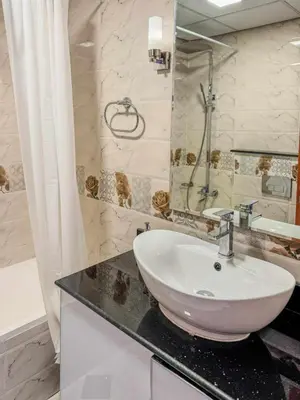 a bathroom with a sink and a shower at Luxury Studio in JVT in Dubai