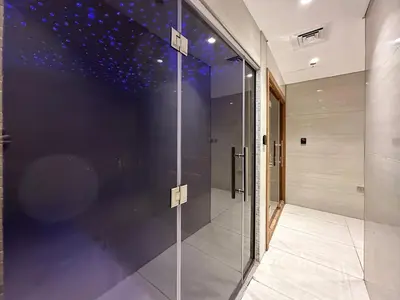 a glass elevator in a building with a star ceiling at Trophy-Luxe Living in a Blue-Hued Haven in Dubai