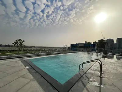 a large swimming pool on top of a building at Trophy-Luxe Living in a Blue-Hued Haven in Dubai