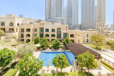 an overhead view of a building with a swimming pool at Al Tajer Residence, Oldtown - 1BR Apartment - Allsopp & Allsopp in Dubai