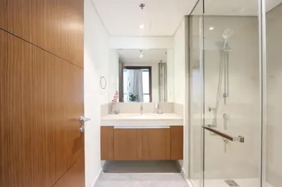 a bathroom with a sink and a shower at Livbnb Creekfront 2BR with Skyline Views Steps to Creek Marina in Dubai