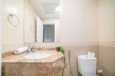 a bathroom with a sink and a toilet and a mirror at Stella Stays Barsha Heights in Dubai