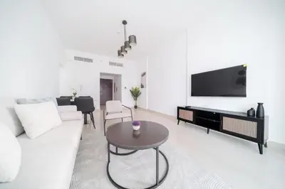 a living room with a couch and a table at Stella Stays Barsha Heights in Dubai