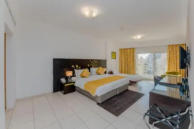 a bedroom with a large bed and a large window at City Stay Prime Hotel Apartments - Al Barsha in Dubai