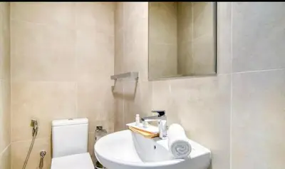 a bathroom with a sink and a toilet and a mirror at Dubai Marina Sea View hotel Apartment in Dubai