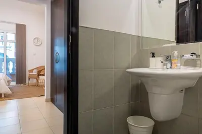 a bathroom with a sink and a toilet at Retro House in Dubai
