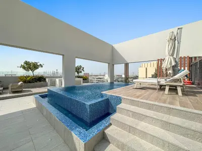 a swimming pool on the roof of a building at Vayk - Modern 2BR with Private Plunge Pool in JVC in Dubai