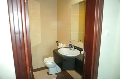 a small bathroom with a sink and a toilet at Stylish 1BR in Elite 7 Sports City in Dubai