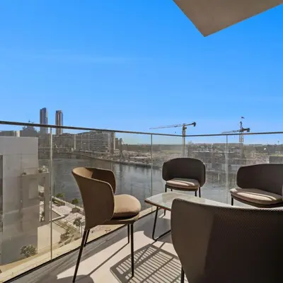 a group of chairs sitting on a balcony with a view at Luxury Canal View-2BR Maid's Room in CF 2, Al Wasl in Dubai