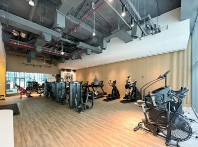 a gym with treadmills and exercise bikes at FIRST CLASS Studio Palm Paradise in Dubai