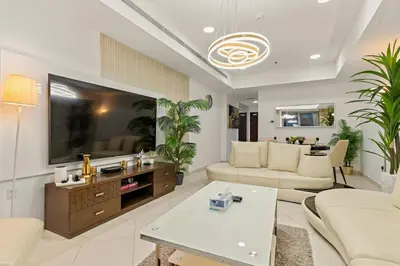 a living room with a large flat screen tv at Luxury 2BR with City Skyline Views Steps to JBR Beach & Marina Mall in Dubai