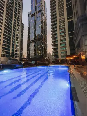 a large swimming pool in a city with tall buildings at Luxury 2BR with City Skyline Views Steps to JBR Beach & Marina Mall in Dubai