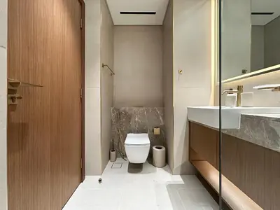 a bathroom with a toilet and a sink at Luxe Living in the Heart of Bbay w Jacuzzi in Dubai