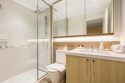 a bathroom with a toilet and a sink and a shower at FIRST CLASS Studio Unwind in Style in Dubai